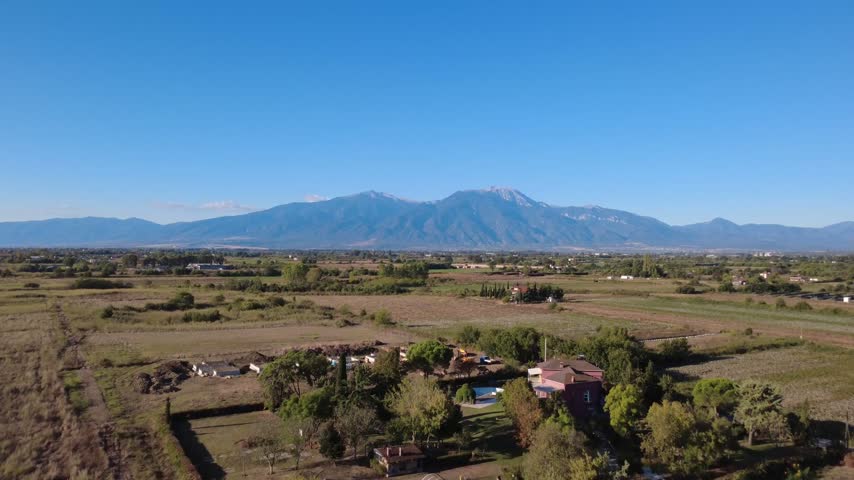 Aerial view of Mount Olympus and the rural landscape near Paralia Katerinis, Pieria, Greece.