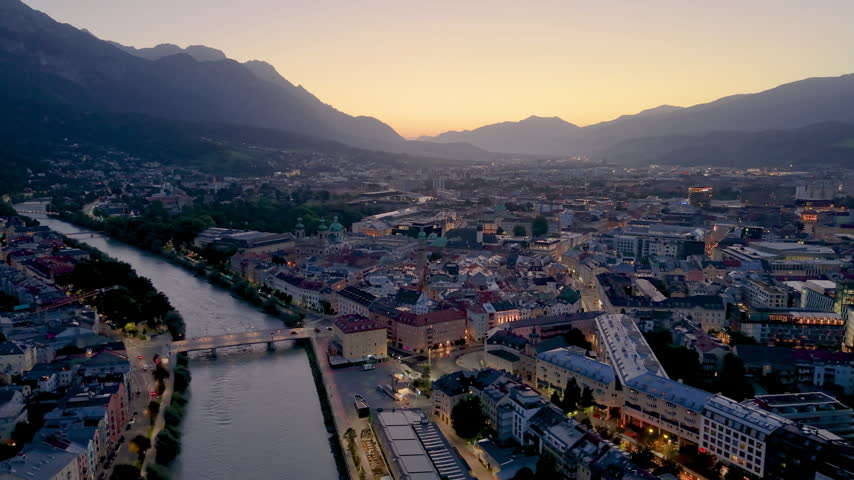 Aerial View of the city of Innsbruck in Austria with mountains and a river under a clear sky