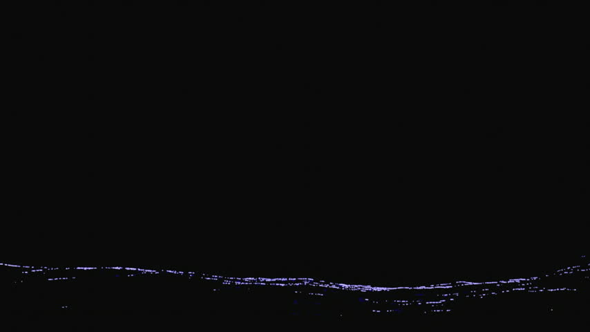 The giant disk of a full moon rises diagonally from behind the horizon of a raging ocean, casting a reflection upon the water.