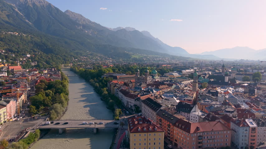 Aerial View of the city of Innsbruck in Austria with mountains and a river under a clear sky
