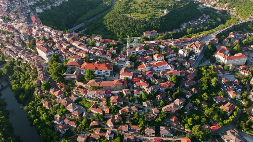 Veliko Tarnovo old town top aerial view red roof houses historic townscape soft sunset light Bulgaria travel clip