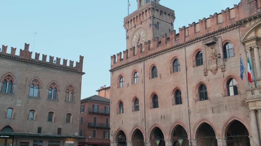 Palazzo dAccursio with clock tower and medieval brick facade on Piazza Maggiore in Bologna old town, Emilia-Romagna, Italy. Italian architecture, European city square, historic urban tourism