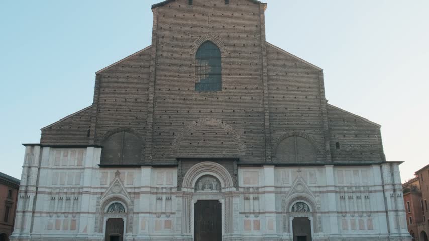 Facade of Basilica di San Petronio on Piazza Maggiore in Bologna, Emilia-Romagna, Italy. Medieval and Gothic architecture in historic city center, Italian old town, European travel and urban tourism