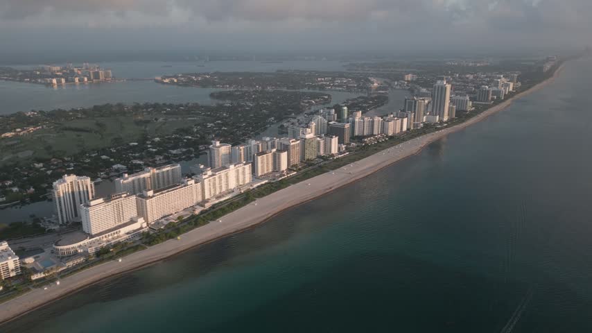 Aerial view of the Miami Beach coastline with high-rise hotels and condominiums lining the sandy beach along the Atlantic Ocean in Miami Beach, Florida, United States.