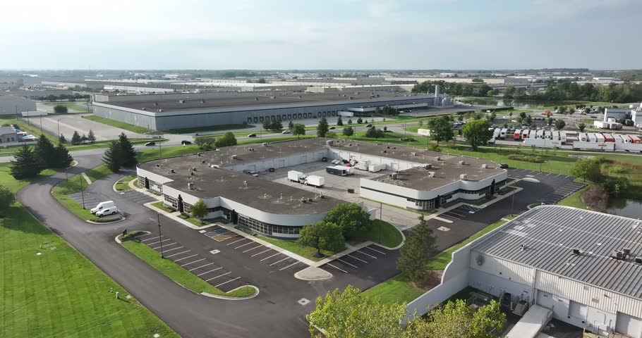 Aerial view of a modern industrial complex with a central courtyard, parking lots, and surrounding warehouses in Indianapolis, Indiana, United States.