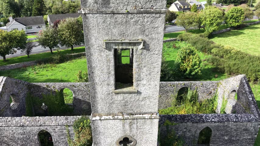 Aerial view of historic Old Roman Catholic Church ruins surrounded by green grounds and stone walls in Ballinrobe County Mayo Ireland.