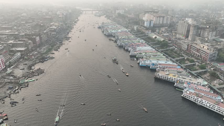 Aerial view of Sadarghat river port with numerous passenger ferries and boats docked along the Buriganga River in Dhaka, Dhaka Division, Bangladesh.