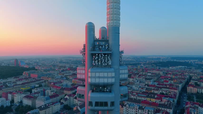 Aerial view of Zizkov Television Tower rising above the historic rooftops and urban landscape of Prague, Prague, Czechia.