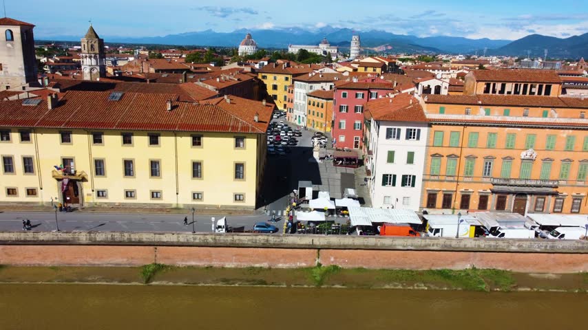 Aerial view of the historic city of Pisa along the Arno river with the Leaning Tower visible in the background, Pisa, Tuscany, Italy.