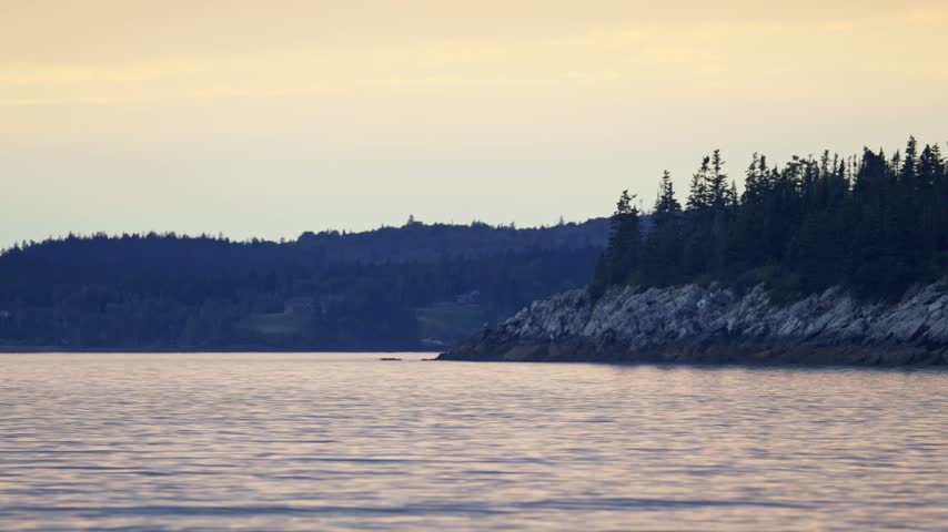 New River Beach Provincial Park sandy tidal shoreline under dramatic overcast twilight skies along the Bay of Fundy, New Brunswick.