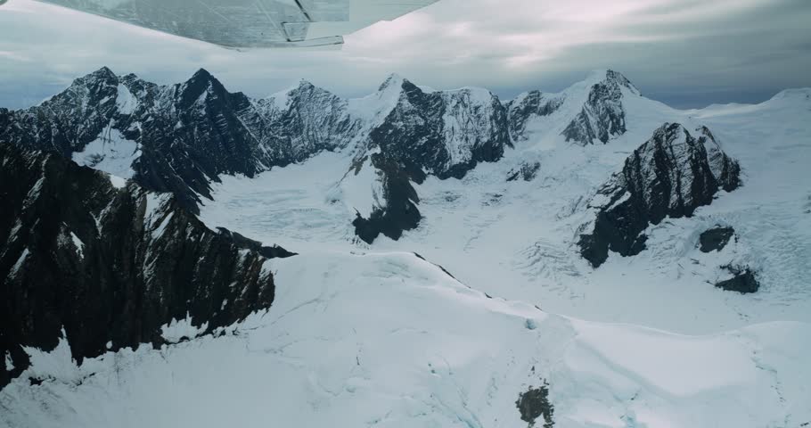 Aerial view of the snow-covered peaks and glaciers of Mount McKinley seen from a small plane in Denali Borough, Alaska, United States.