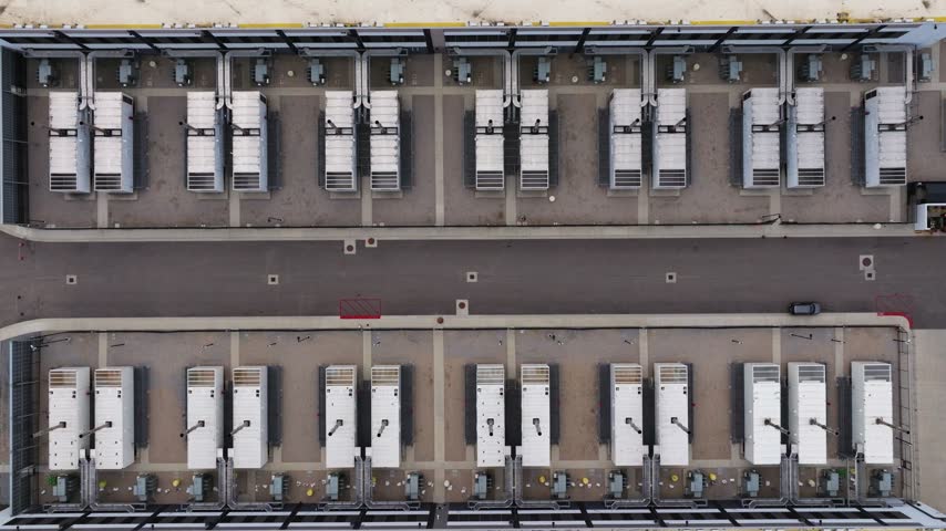 Aerial view of rows of white industrial power units arranged in a grid pattern at a facility in the United States.