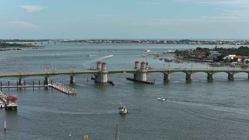 Aerial view of the historic Bridge of Lions spanning the Matanzas Bay with boats sailing nearby in St. Augustine, Florida, United States.