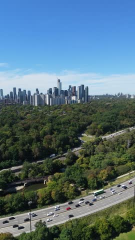 Vertical aerial of Toronto east end waterfront from park tennis courts to Lake Ontario shoreline, drone footage