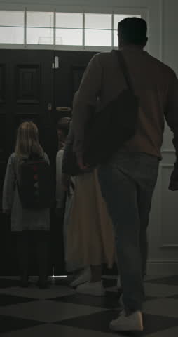 Leaving, parents and child at front door in home ready for school, work and commute together. Family, house and back of mom, dad and girl with morning routine for education, career and start day