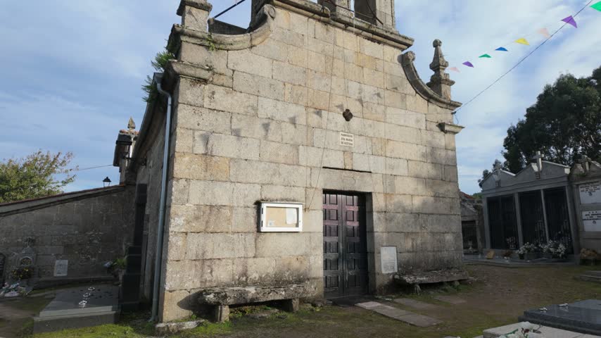 Stone Santa Maria de Xestosa church in Toen, Ourense, Galicia, Spain beside village street
