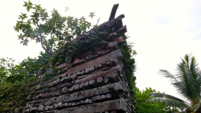 Closeup pan down tall stone walls of Nan Madol buildings in Madolenihmw district, Pohnpei, Federated States of Micronesia