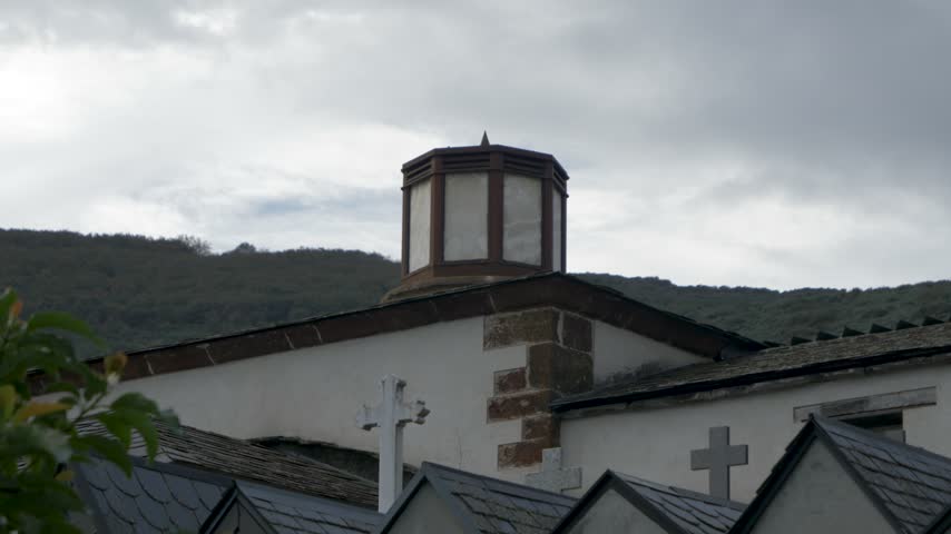 Octagonal roof lantern rises above the slate roofs of the Church of San Pedro de Correxais