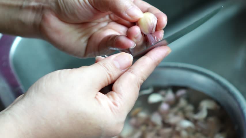 Peeling Garlic Clove with Knife in Home Kitchen, 4K