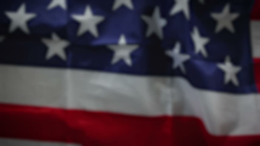 American 4th of july flag waving in the night fireworks sky. 4K.
