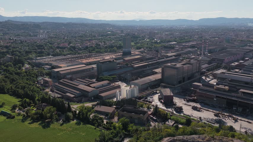 Aerial view of the Acciai Speciali Terni steel plant complex with industrial buildings and warehouses in Terni, Umbria, Italy.