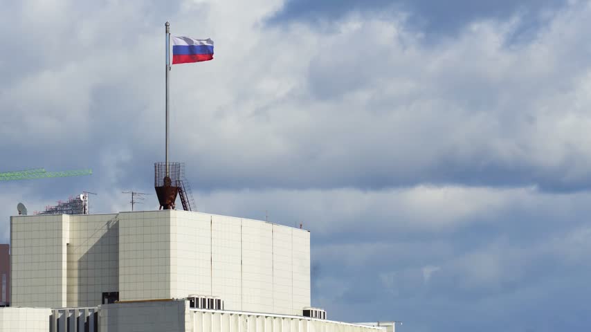 Russian flag atop the Primorsky Krai Government building in Vladivostok video, symbolizing regional administration and national identity.
