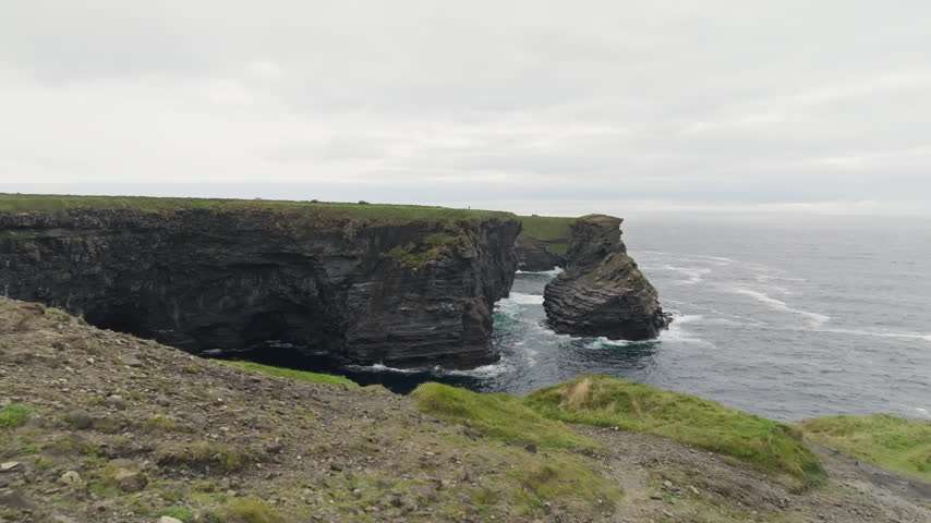 Diamond Rocks on the Kilkee coast in County Clare, Ireland, features aerial sea cliffs and an offshore rock stack above Atlantic surf, a destination for coastal sightseeing.