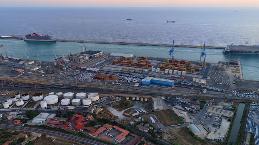 Aerial view of Civitavecchia Port with cruise ships, cargo containers, and industrial facilities in Civitavecchia, Lazio, Italy.