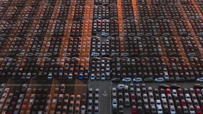 Aerial view of thousands of new cars parked in rows at the Civitavecchia Port automotive terminal in Civitavecchia, Lazio, Italy.
