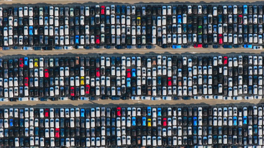 Aerial view of rows of new vehicles parked at the automotive terminal in Civitavecchia Port, Civitavecchia, Lazio, Italy.
