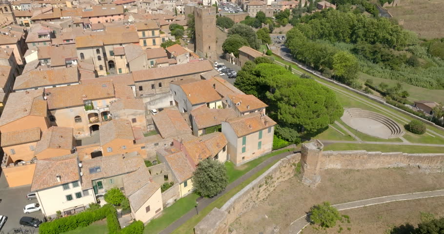 Aerial view of Torre di Lavello Park with its small open-air amphitheater beside the medieval walls of Tuscania, in the province of Viterbo, in Lazio, Italy, with the Torre di Lavello, on a sunny day.