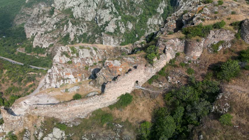 Ruins of the stone defensive walls of Baghaberd Fortress built along a steep rocky slope in Syunik Province, Armenia.