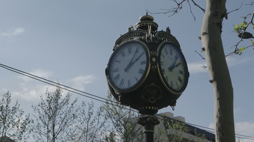 Small ornate clock tower on the roadside in Bucharest