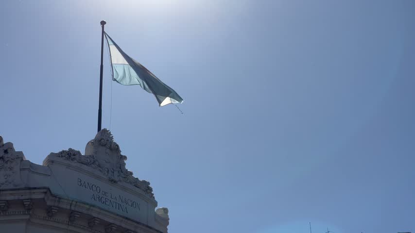 The Argentinian flag waves atop the Banco de la Nacion building in Buenos Aires Argentina
