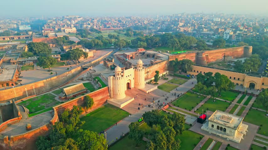 Aerial drone view of historic Lahore Fort and surrounding landmarks in Lahore, Pakistan.