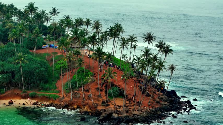 Beautiful tropical beach with palm trees and rocky coastline scenery