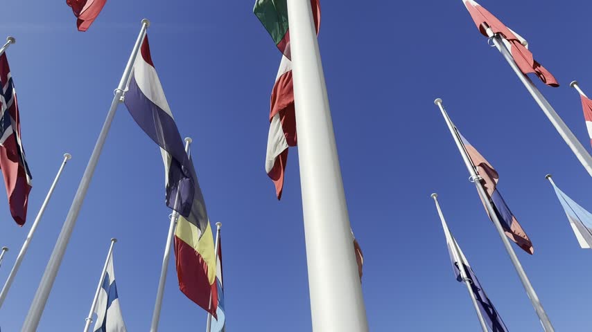 Flags weaving in the wind on a blue sky