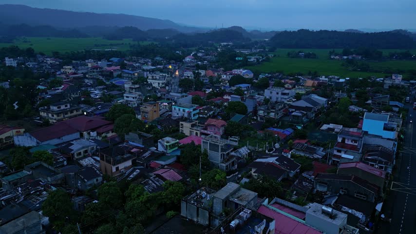 Cinematic aerial view of Buhi town and Lake Buhi during blue hour in Camarines Sur, Philippines. The footage features the urban and lakeside areas around San Benito, San Pascual and Santa Cruz