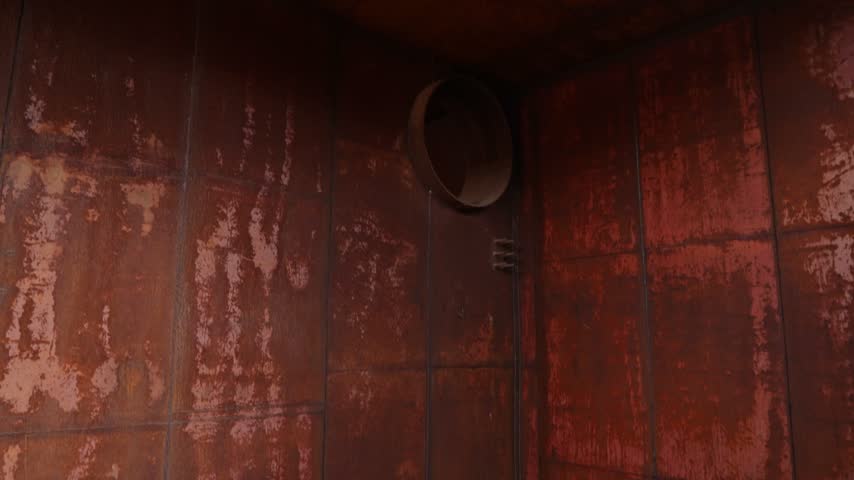 Interior view of an abandoned silo in Moldova, showing heavily rusted metal walls, circular openings and decayed industrial structures with a dark Cold War atmosphere.