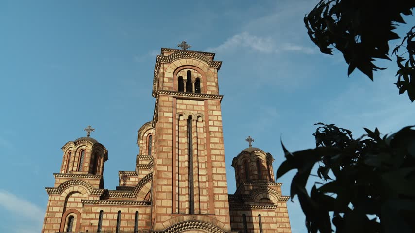 Saint Mark Church rises against a blue sky in central Belgrade Serbia. The footage suits religion architecture tourism heritage and European travel themes