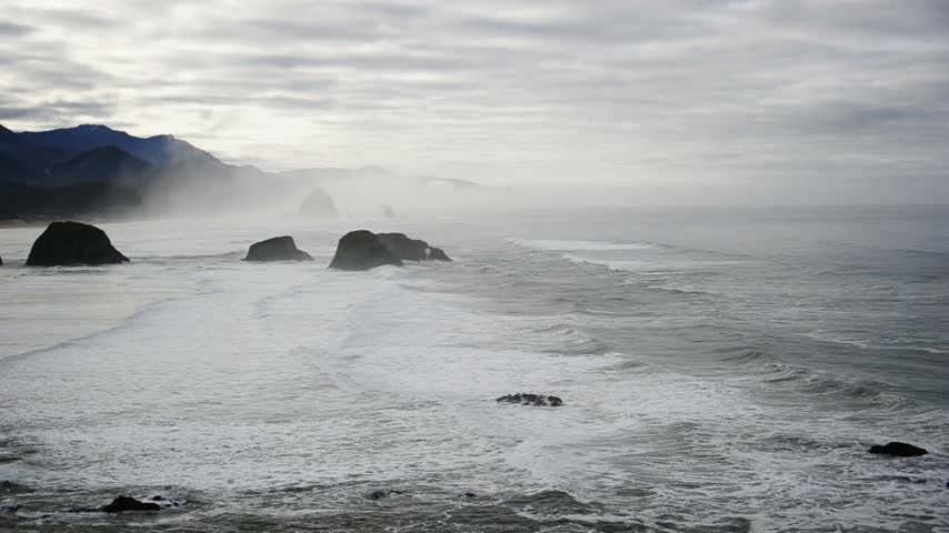 View of Ecola State Park.Standing at Ecola Point, seeing the ribbon of sand between layers of forested hills and sea stacks jutting out from the Pacific Ocean,Oregon, United States.