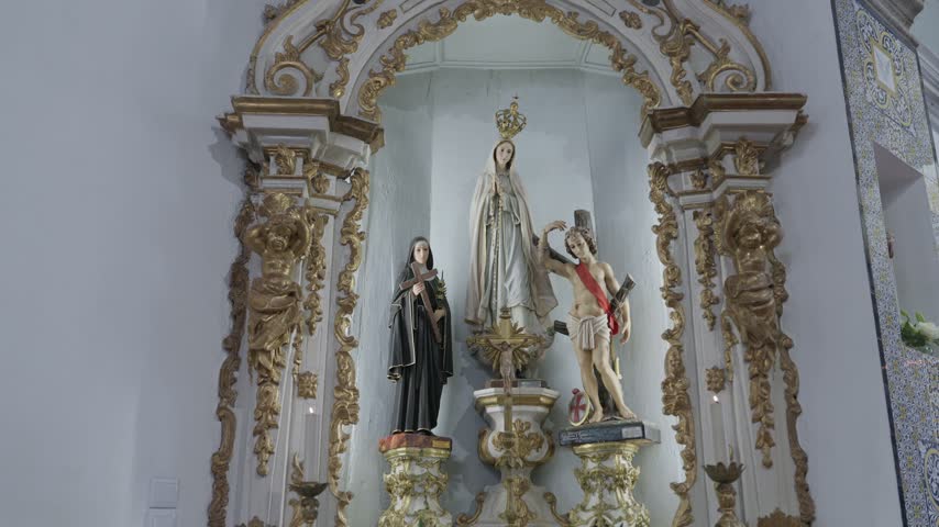 A gilded baroque altar niche with statues of Our Lady of Fatima, a nun holding a crucifix and Saint Sebastian, beside an azulejo tile panel.