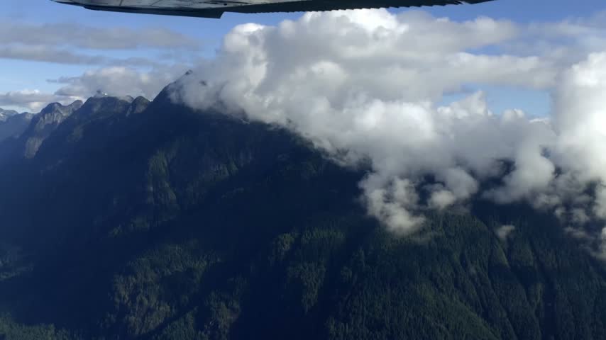 Dense Clouds Over Forested Mountain Ranges With Expansive Green Woodland. Handheld, POV Shot