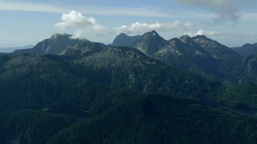 Rugged Mountain Ridge Covered In Dense Evergreen Forest, Scenic Wilderness Landscape In British Columbia, Canada. Handheld Wide Shot