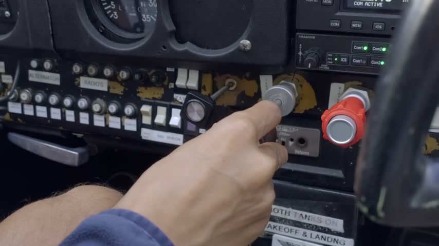 Person On Aircraft Control Panel Inside A Flight Simulator With Switches, Gauges, Controls, And Instrument Displays. Close-up Shot