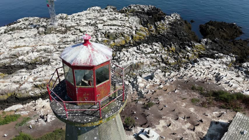 Experience an enchanting aerial perspective of the lighthouses in Nova Scotia, Canada, revealing the rugged coastline and vibrant ocean from above.