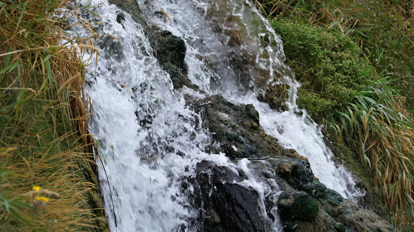 Close-up of a waterfall flowing down the moss covered rocks at Falls Creek Falls in Idaho.