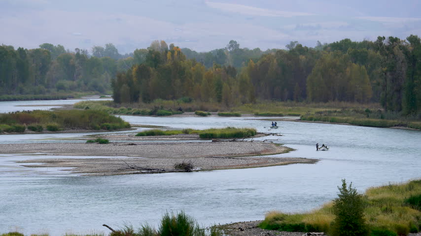 Looking up the Snake River as fishermen float down through Swan Valley Idaho.