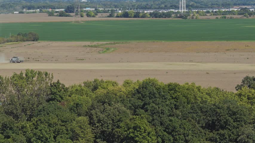 Drone aerial wide view and landscape establishing shot of countryside rural Ohio outside Columbus, OH by London as midwestern state with cornfields, farm land, huge fields, roads, highway, and trees