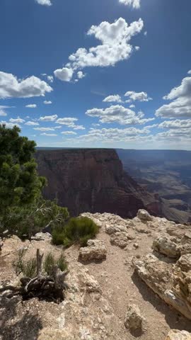 A breathtaking view of the Grand Canyon in Arizona, USA, from a bird’s‑eye perspective. A woman is Traveling through the sights and national parks of America.